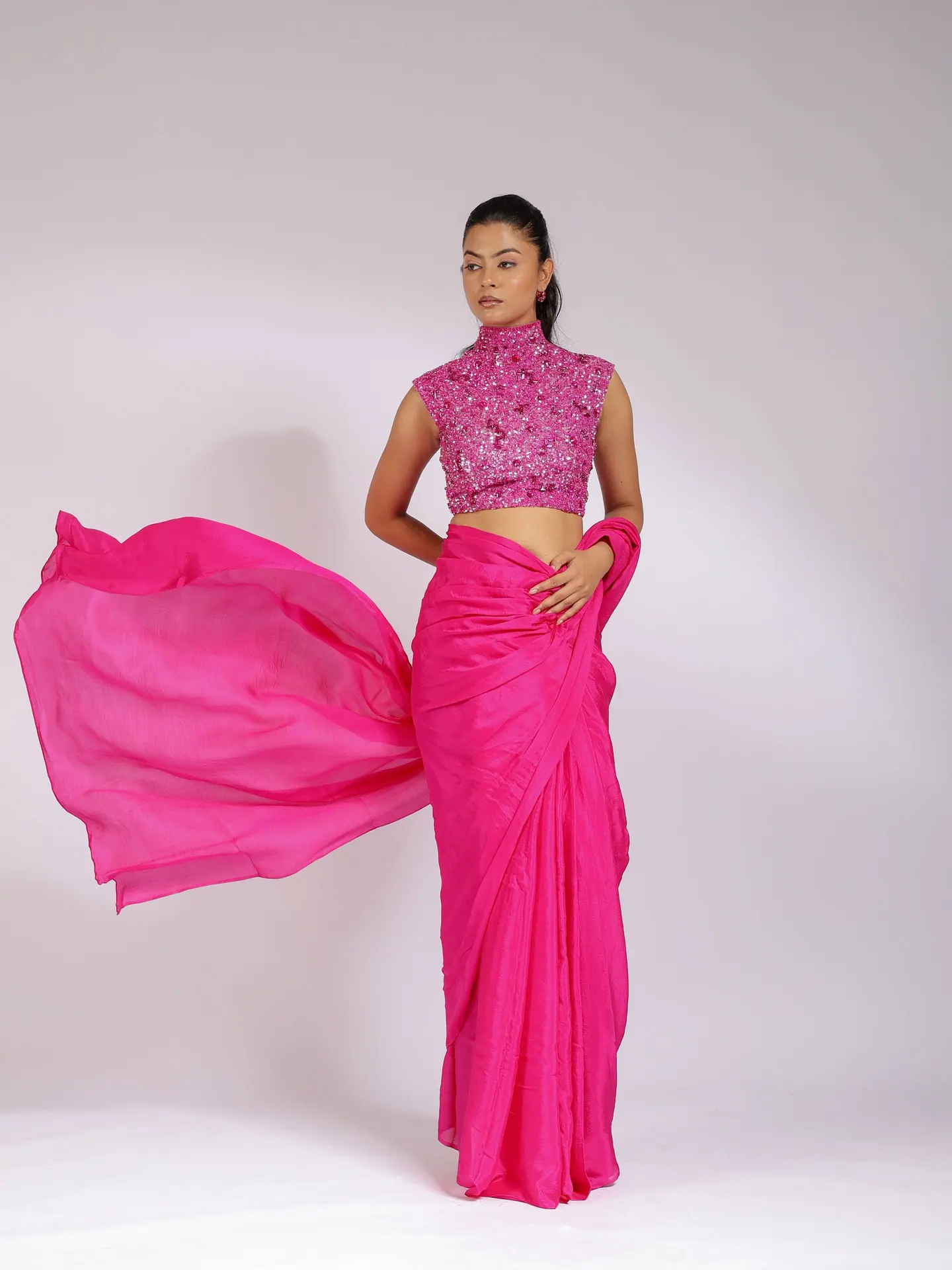 Fuchsia saree pallu caught mid-air