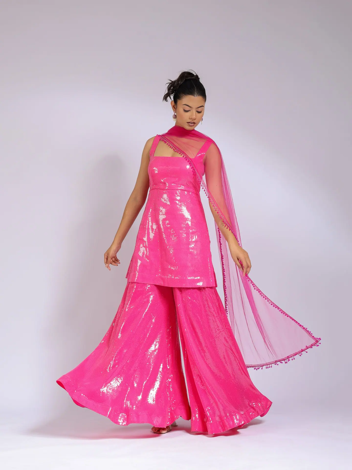 Hot-pink sequin sharara set in motion, dupatta flaring out