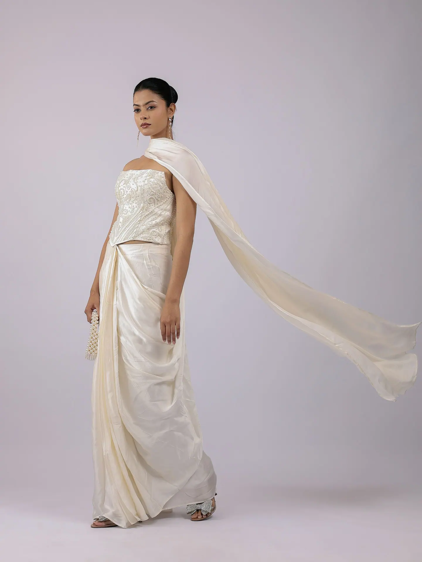 Ivory draped set with the cape caught in the air