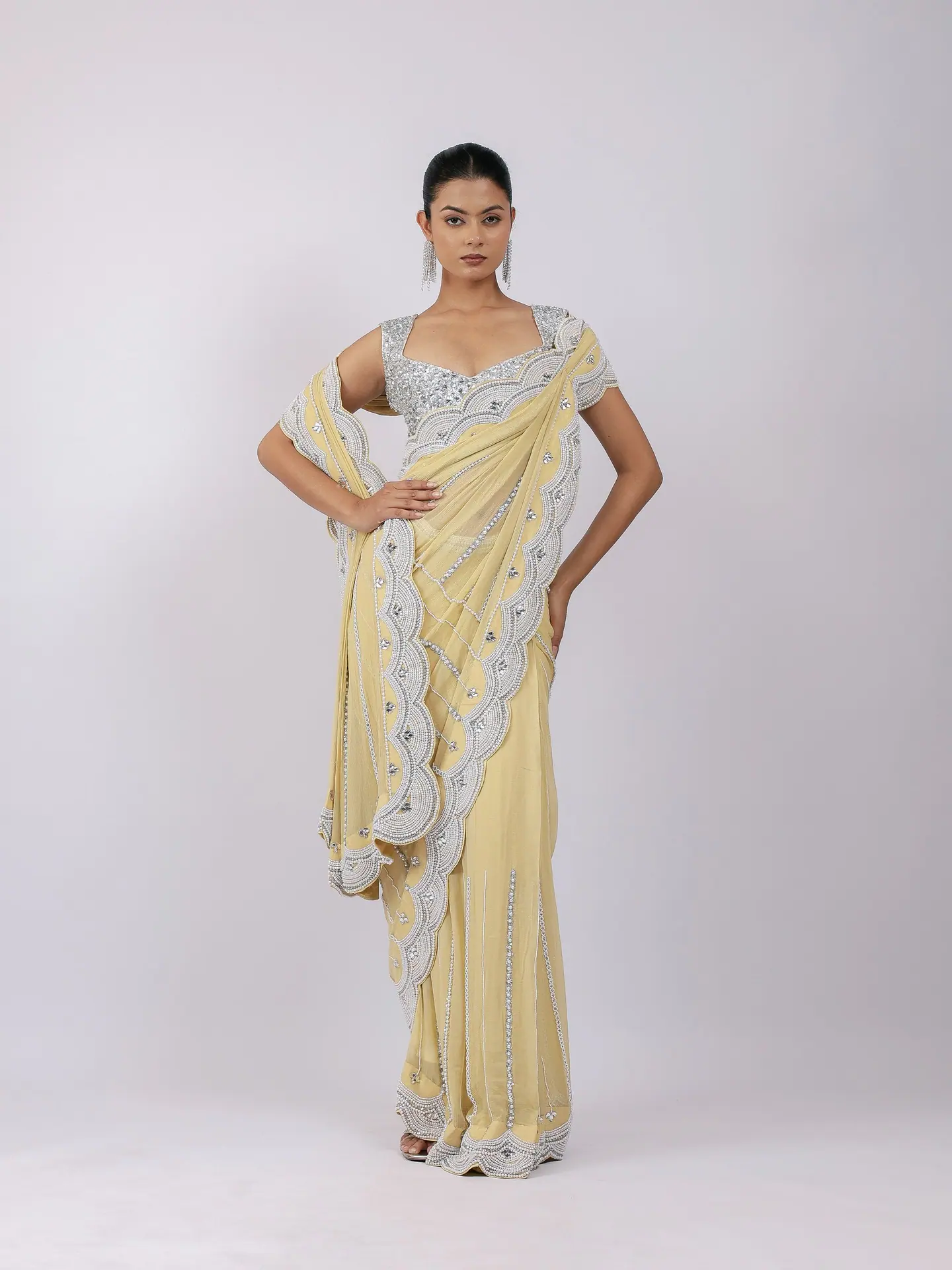 Lemon saree with a scalloped embellished border, full length