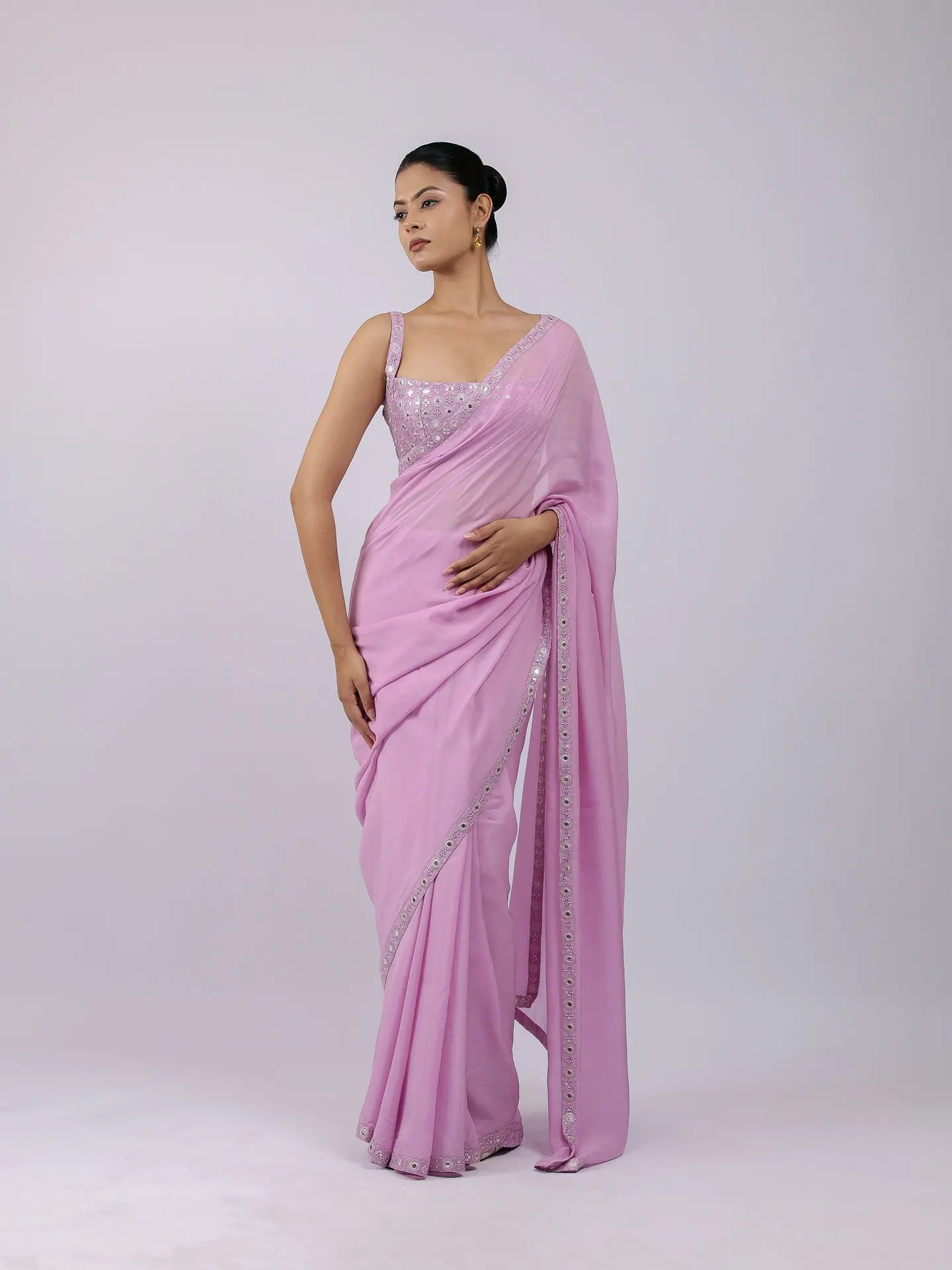 Lilac saree with a mirror-work border and sleeveless blouse, full length