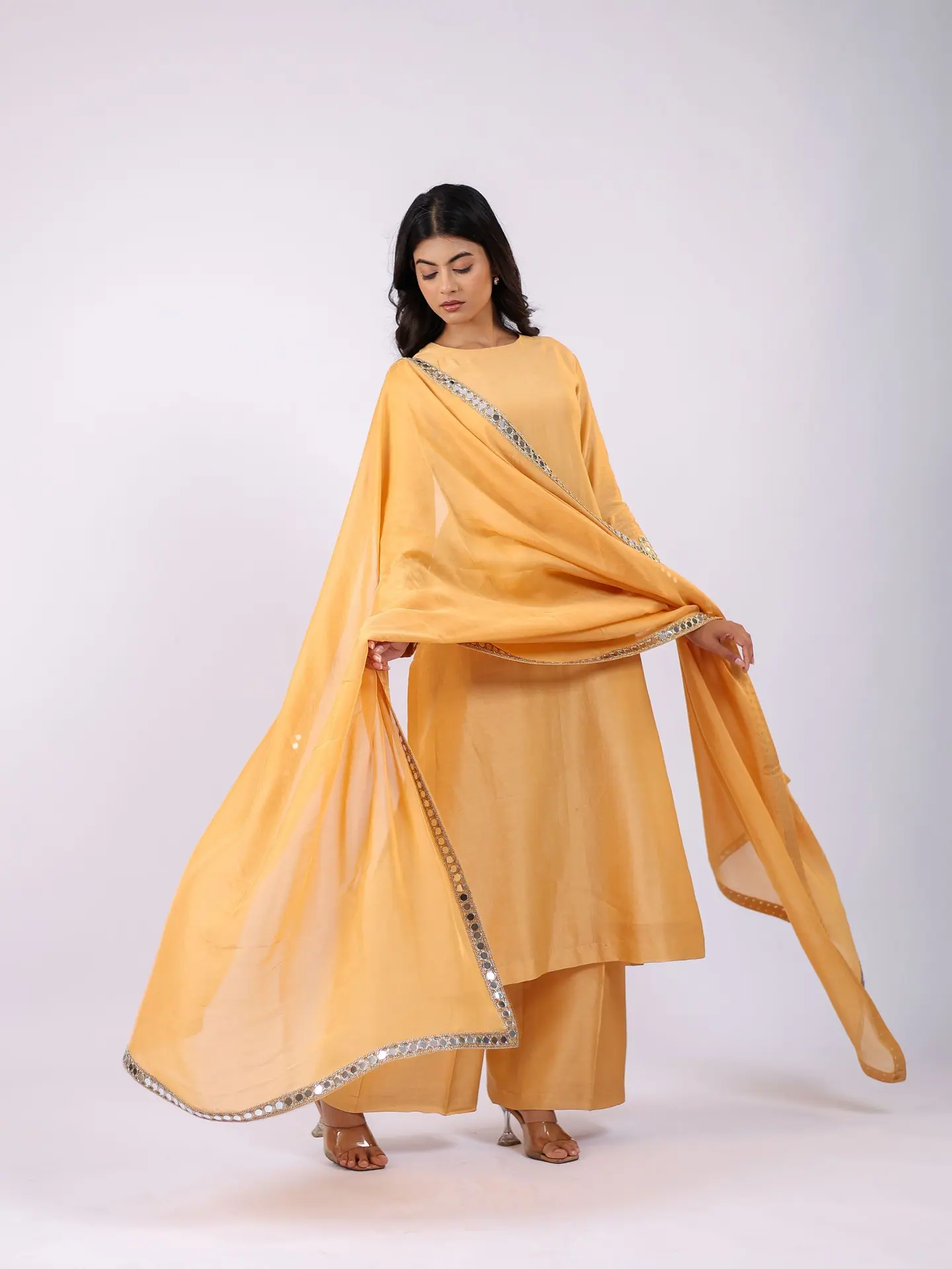 Marigold dupatta held wide behind the shoulders