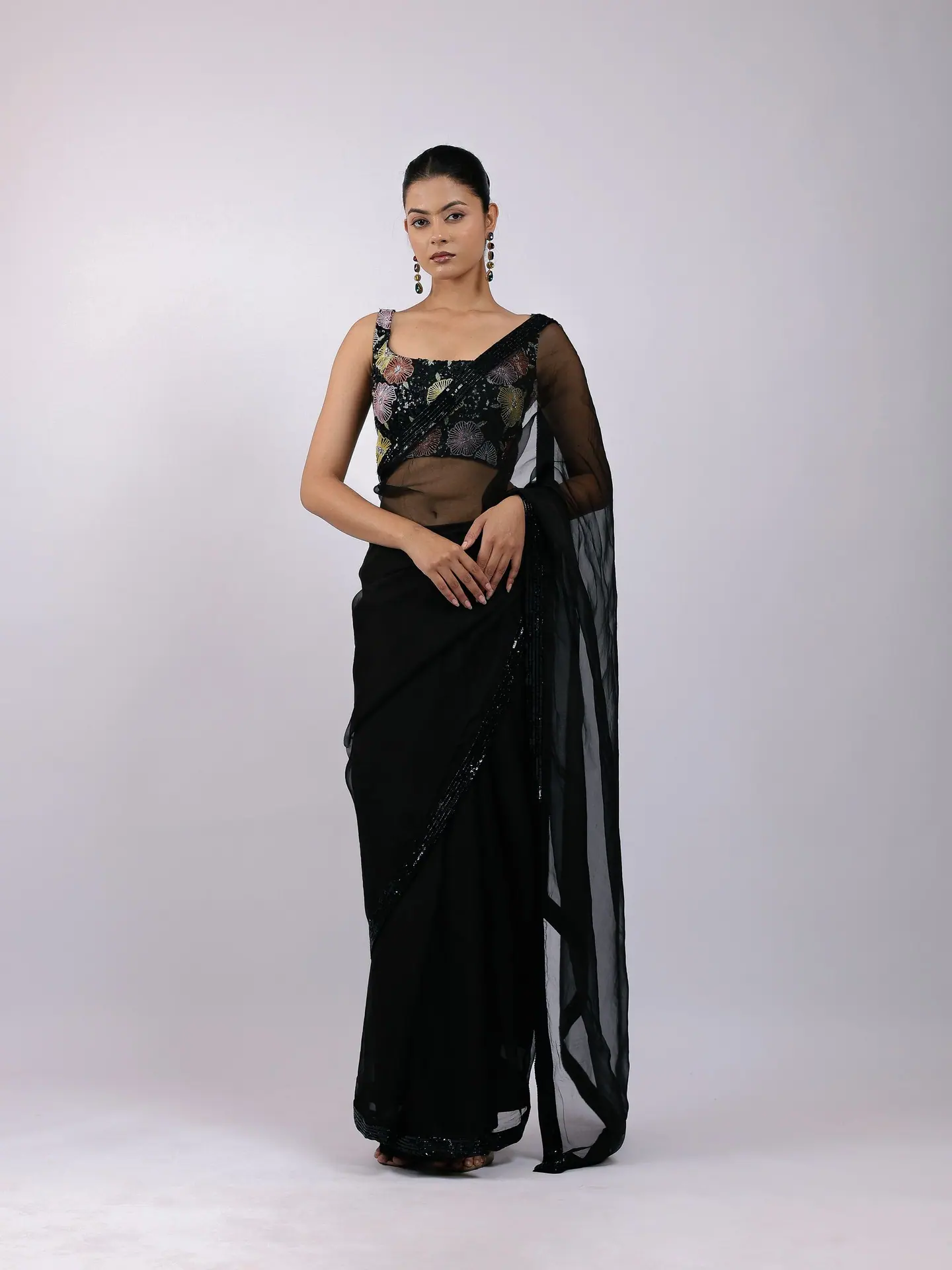 Black sheer saree with a floral embroidered blouse, full length