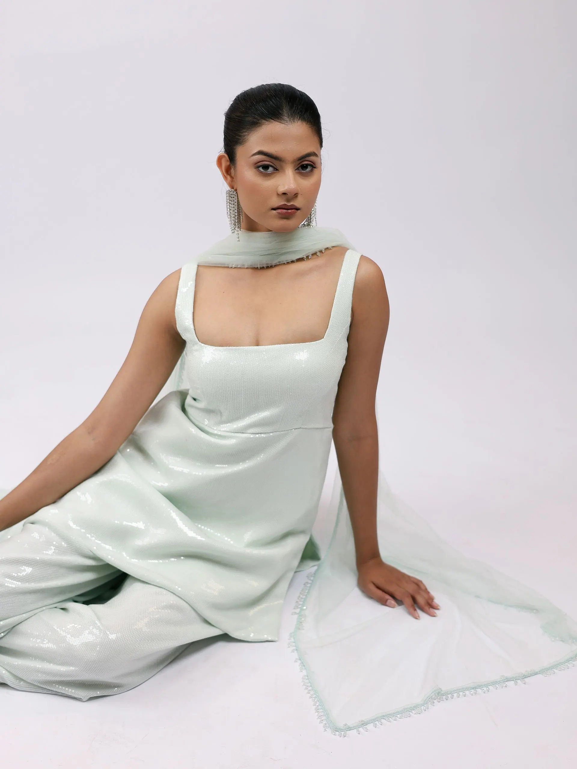 Model seated in the mint sequin set