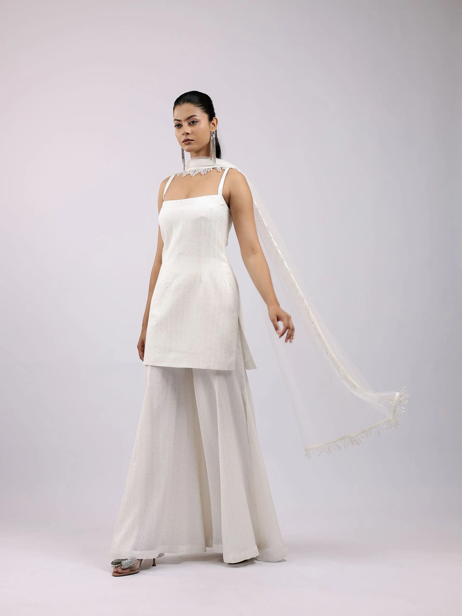 Ivory strappy kurta and sharara with a long pearl-fringe dupatta