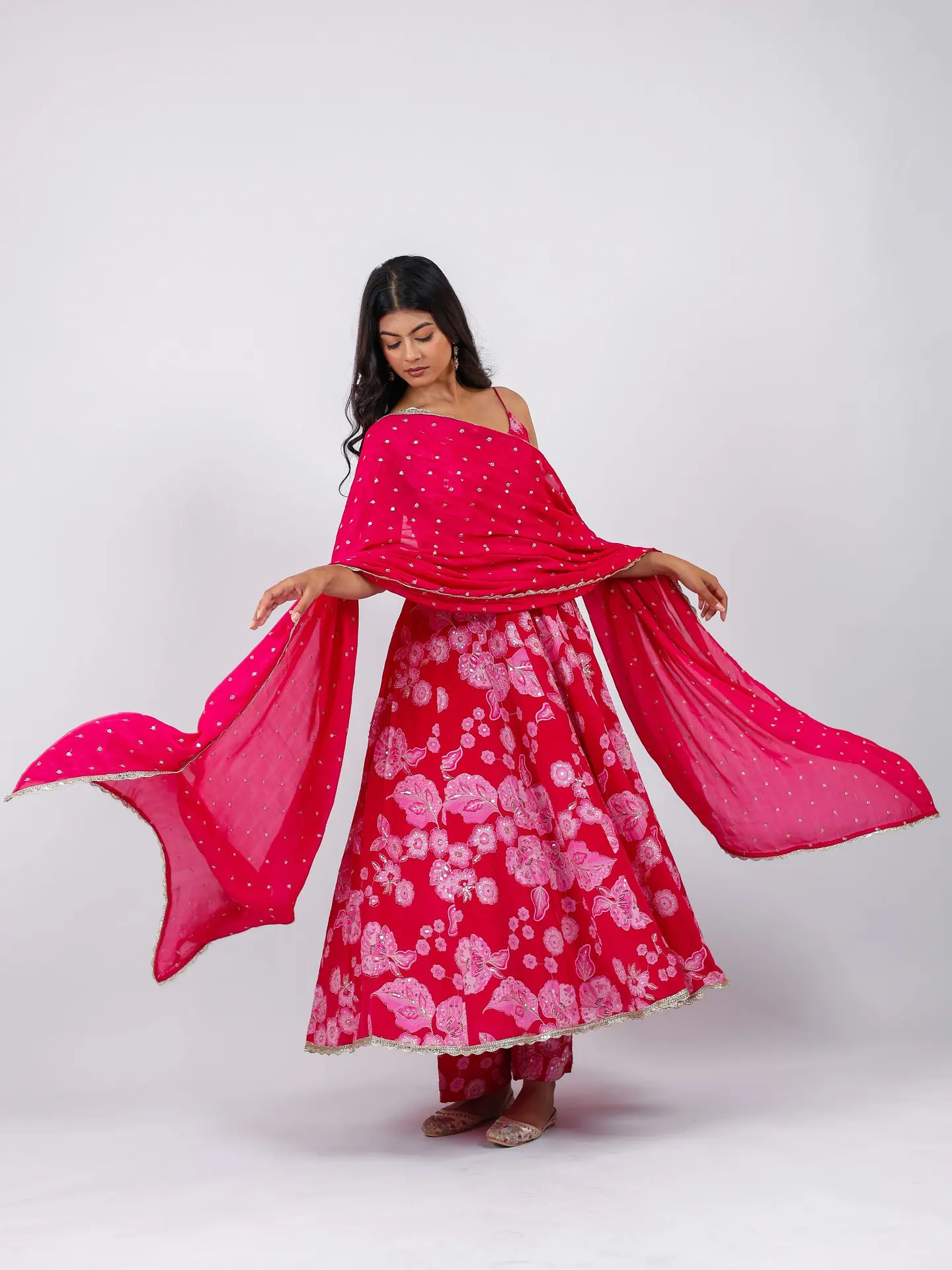 Rani-pink anarkali with the dupatta held wide
